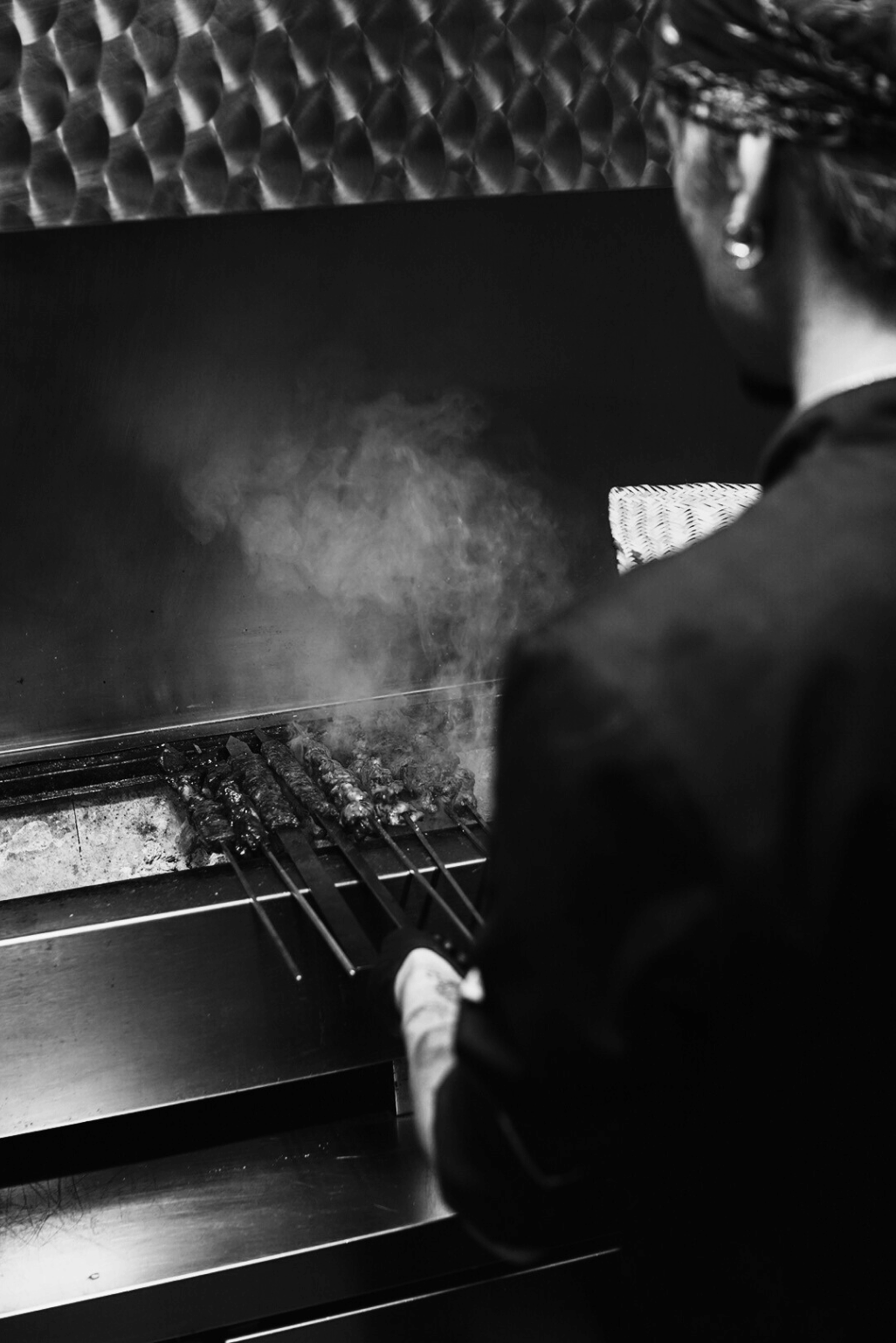 Chef placing cheese on raw pizza bread